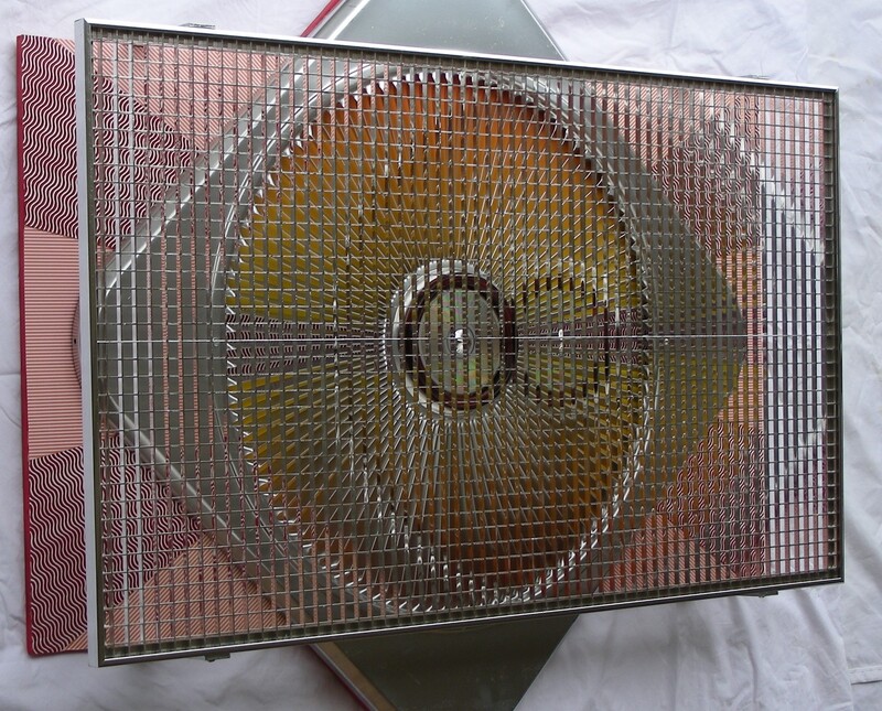 Fanburst is a mixed media hanging sculpture that uses a reflective grid over an arrangement of patterned backdrop surfaces to create elaborate moire effects.  The base layer is has a variety of painted and printed papers, topped with a repurposed industrial fan cover, and with a centerpiece of a rim from a dime store vanity mirror, a compact disc, and the cap from a broken holiday tree ornament.  The outer layer is a reflective light diffuser for a ceiling fixture.  As the viewer moves to the side, the reflective material shifts and mixes the base layer patterns in a way that makes them seem to levitate, free of their media.  You can see the effect of moving around Fanburst in this video.